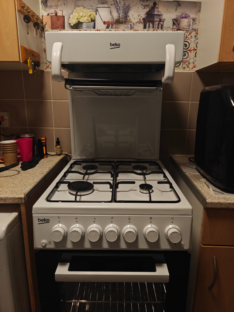 White Beko gas cooker with eye-level grill installed in a compact kitchen