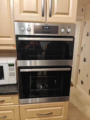Stainless steel AEG built-in double oven integrated into kitchen cabinetry